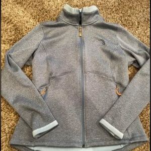 The NorthFace zip up. Light blue/gray color.